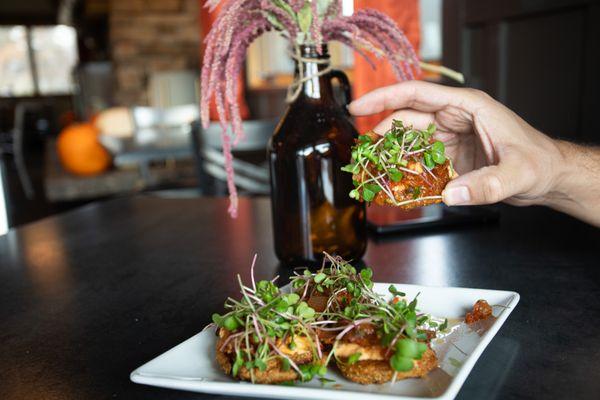 BLT BITES: Fried green tomato, pork belly, pimento cheese, tomato jam, UM campus-grown micro radish greens