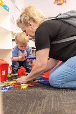 Child and caregiver play in our Knowledge Nook Exhibit.