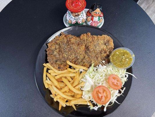 Milanesa- Breaded Beef served with French fries, lettuce and tomatoes.