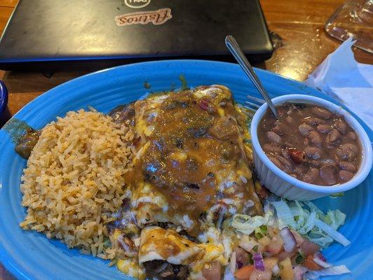 Carne guisada enchiladas with extra hot green chile sauce