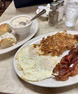 Eggs, bacon, crispy hash browns with biscuits and sausage gravy. Cost: 13.71 plus tip.