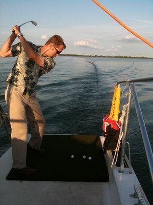 Golfing off the rear, aiming at a small boat towed behind Chamonix II, as a part of a contest. I got a "Boat-In-One"