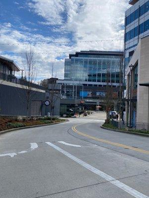 Entrance to parking on the bottom left and stores on the right lane