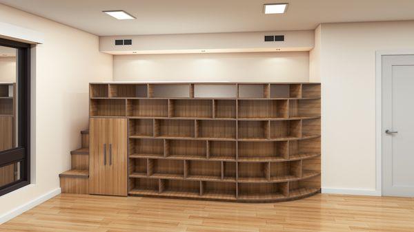 Queen sized loft bed behind mega bookcase with curve. Mini door leads to under-bed storage. Big staircase also provides cubby storage.