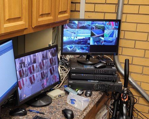 A CCTV setup with cameras viewed on screen. Key fobs on  counter.