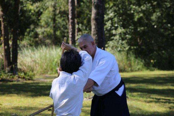 Weapons practice with Jyo, or wooden short staff.