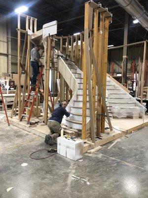 Craftsmen work on a custom curved staircase in the shop at National Millwork in Mansfield, MA