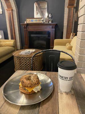 Large black coffee and Brick City sausage bagel sandwich