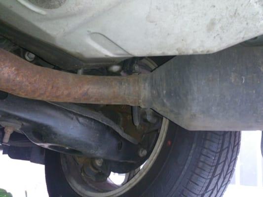 Where their rusted exhaust pipe meets my rear cat and exhaust pipe They did a good job with the welding.  Criminals