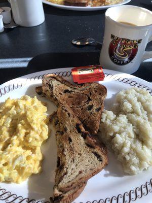 Cheesy eggs, raisin toast and grits.