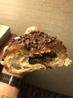 Chocolate chips inside of the chocolate chip donut.