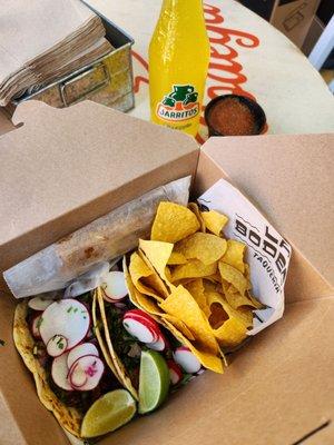 Lunch box! 2 Tacos, chips and salsa and 2 churros. Pineapple soda was extra