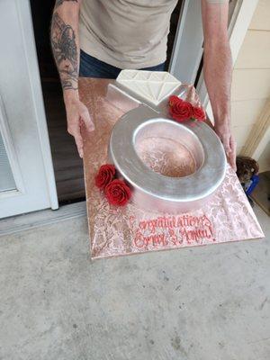 Bringing out the engagement ring cake