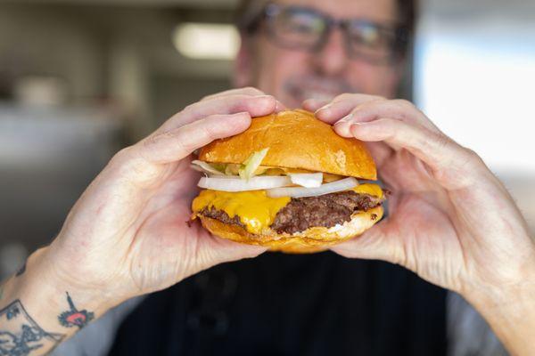 sSmash Burger! 1/3 lb Angus beef, ranch, iceberg lettuce, American cheese, white onions, challah roll, and a house-made sauce! Try it!