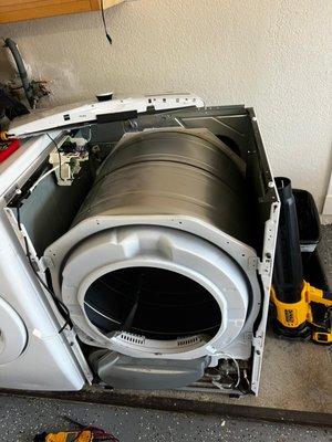 Partially disassembled LG dryer undergoing repair due to the drum not spinning.