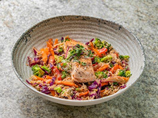 Thai Stir Fry bowl with veggies, caulirice covered in Sesame Ginger Sauce and topped with your choice of clean protein - salmon or chicken