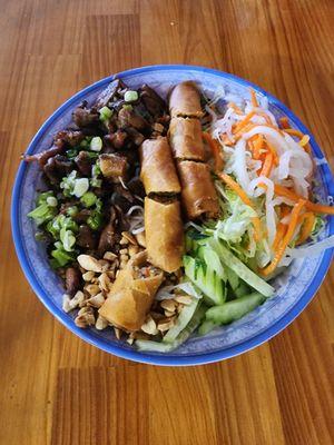 Noodle salad with grilled pork and fried spring roll. Dressing on the side.