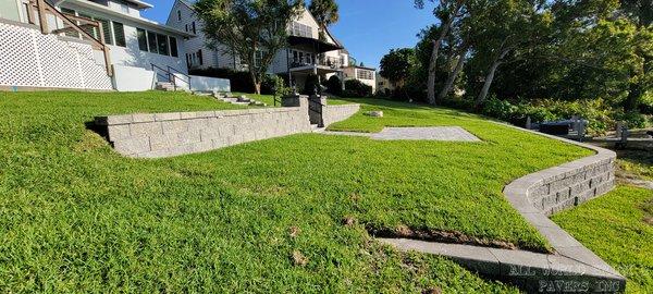 Two-Tier Retaining Wall with center stairway, Lightings and Pavers. Lake Highlands, Orlando, FL.