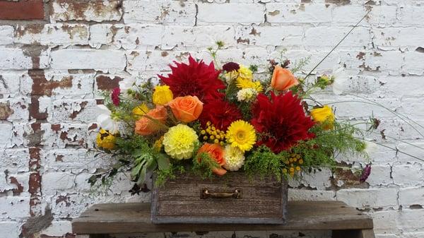 Seasonal blooms in a decorative box.