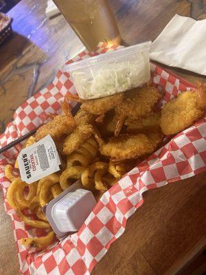 Fried shrimp, coleslaw, and curly fries