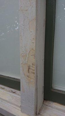 They used wood filler to conceal still-chipping paint rather than scraping and stripping it off.