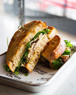 Roast Pork Sandwich [shaved pork, salsa verde, arugula, gruyere, roasted
 garlic aioli, toasted sourdough]