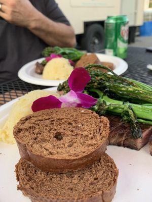 Steak dinner for two with mashers and broccolini.