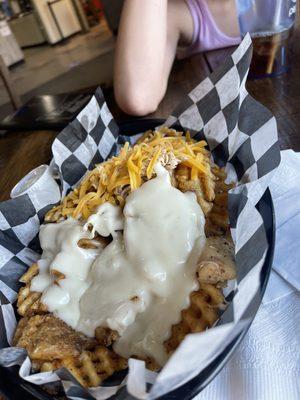 Loaded Waffle Fries with Shredded chicken. We got half shredded cheese half queso, highly recommend getting the queso!