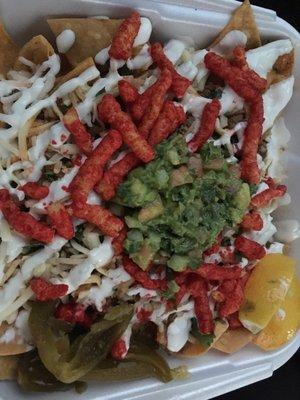 Carne asada nachos with everything on it plus hot Cheetos.