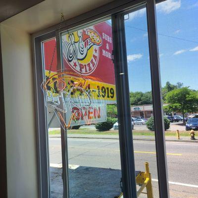 Exterior sign from New large windows letting in so much natural light making Dining in very appealing