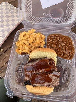 Beef brisket sandwich with Mac and cheese and bake beans.