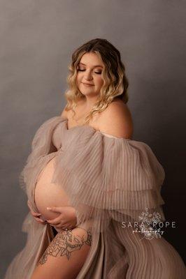 Whimsical glamor maternity session portrait captured at photography studio