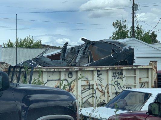 Burnt out car in dumpster