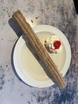 Churro with whipped cream and a cherry .  Our awesome server divided in half for us.