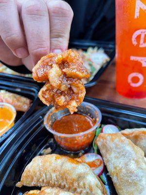 Zero Degrees' Fried Dumplings include five cooked pork and veggie dumplings, served alongside signature house spicy sauce.