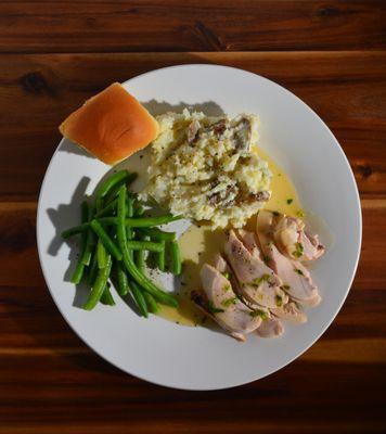 Grilled Chicken Breast with a Honey Jalapeño Glaze, served with mashed potatoes and green beans.