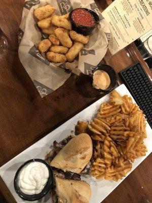 Gouda cheese bites and steak sandwich with waffle fries