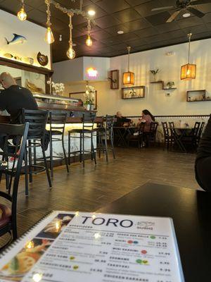 Restaurant remodel has tables and a bar to sit at to watch the sushi be made