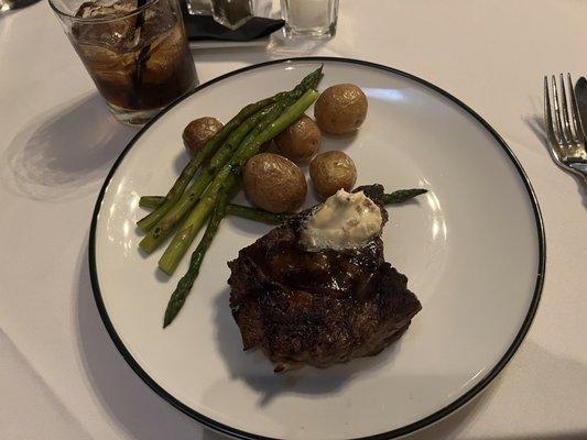 Ribeye steak with madeira demi glaze, creamer potatoes, & asparagus.