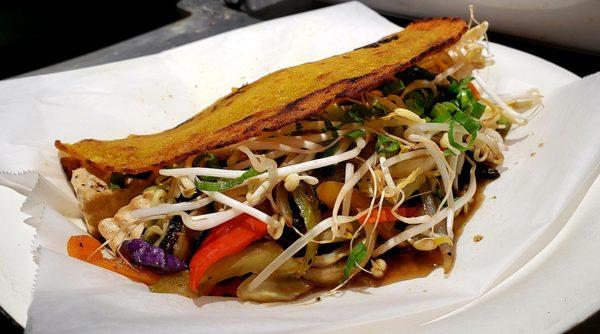 Bánh Xéo with tofu, coconut-rice crepe, bell pepper, onion, sprouts, and shitake mushroom sauce.