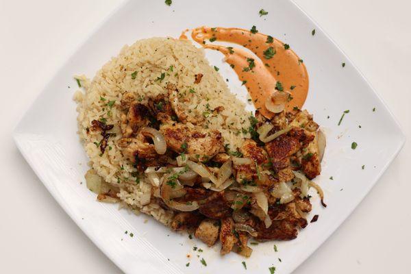 Chicken Shawarma Platter served with grilled onions over a bed of rice