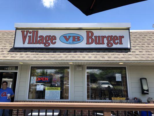 Village Burger sign in the storefront.