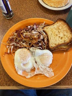 Corned beef hash, eggs, and Gluten-free toast.