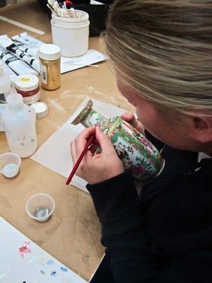 A porcelain repair mid-process: fine hand-painted detail which takes a great eye for color and a very steady hand!