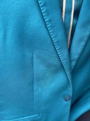 Teal blazer with stain. Dry cleaner said he didn't do it, he wouldn't clean it again and he wouldn't refund my money.