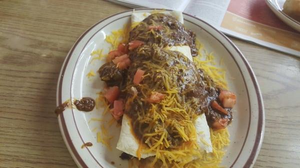 Breakfast burrito topped with chili.