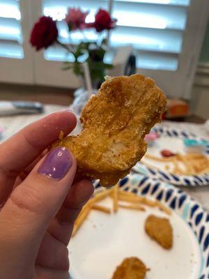 Both of my chicken nuggets were stuck together and a peace of my chicken fell off