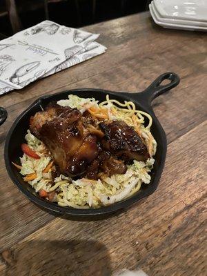 Braised pork belly on a bed of crisp noodles