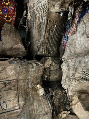 Peeking down a tunnel of rotten, soaking wet boxes