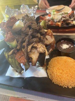 Personal Molcajete (chorizo, steak , chicken , pork and cactus) comes with yellow rice and black beans.